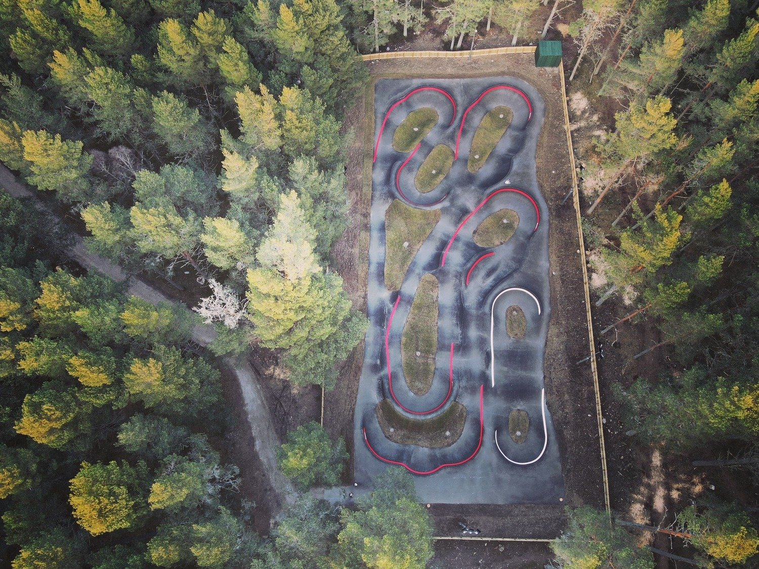 An aerial view of a pump track in the landscape
