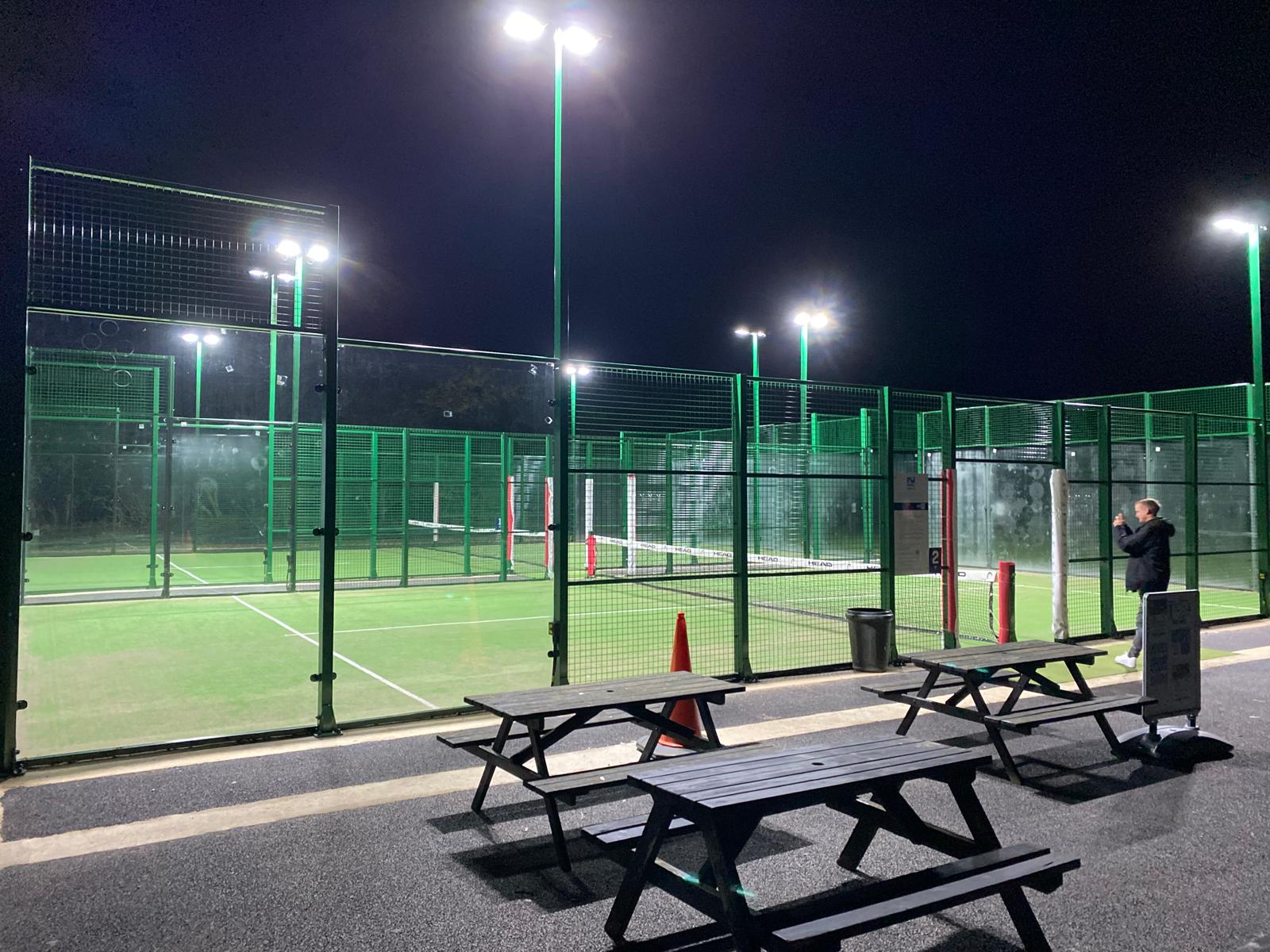 A floodlit tennis court